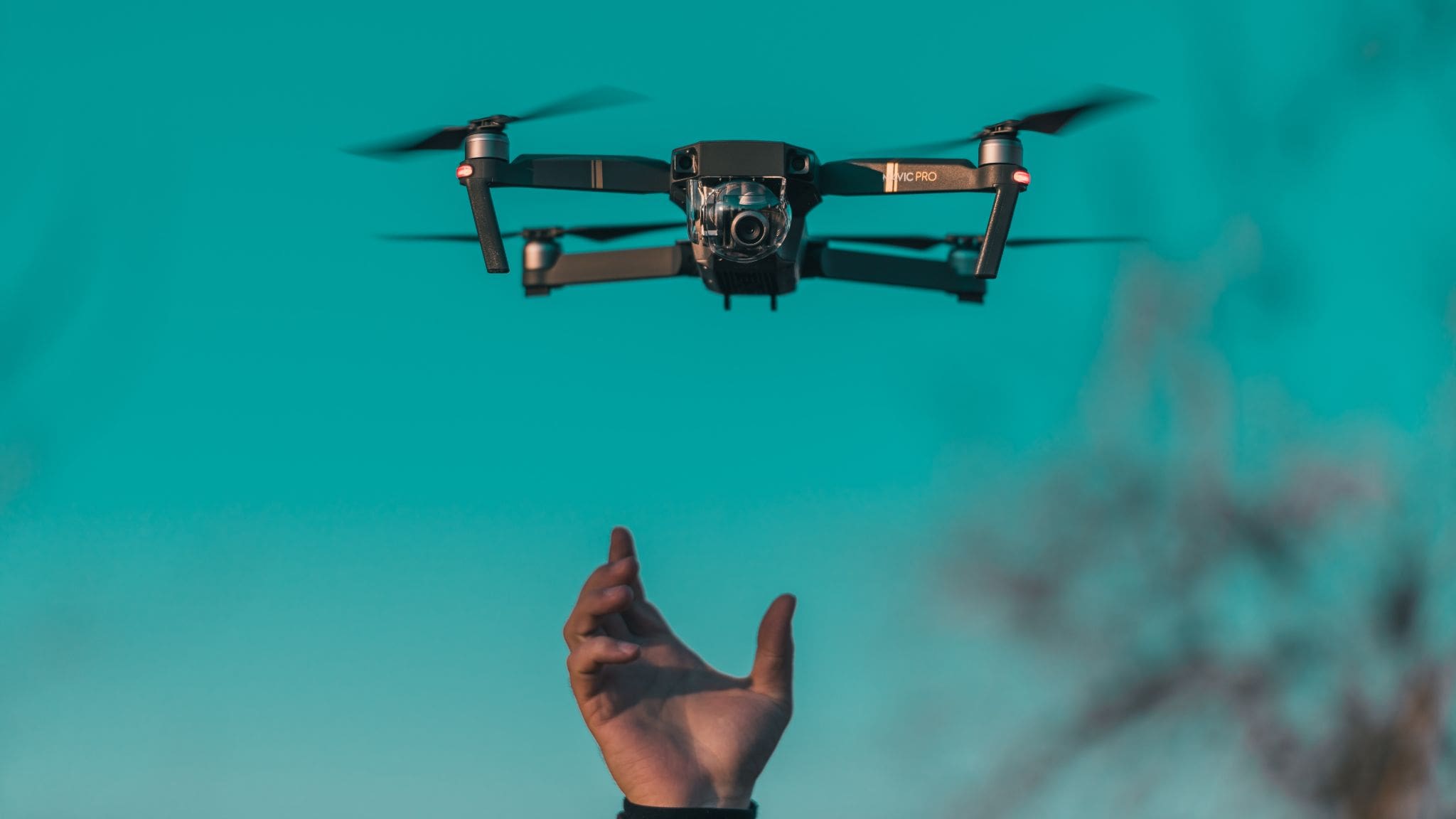 Hand reaching for the drone