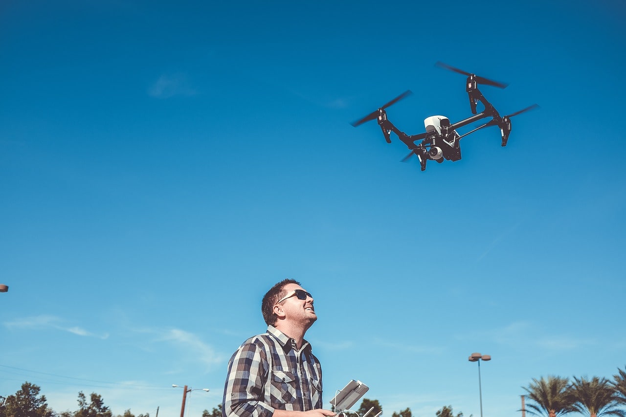 Man flying a drone in a city area