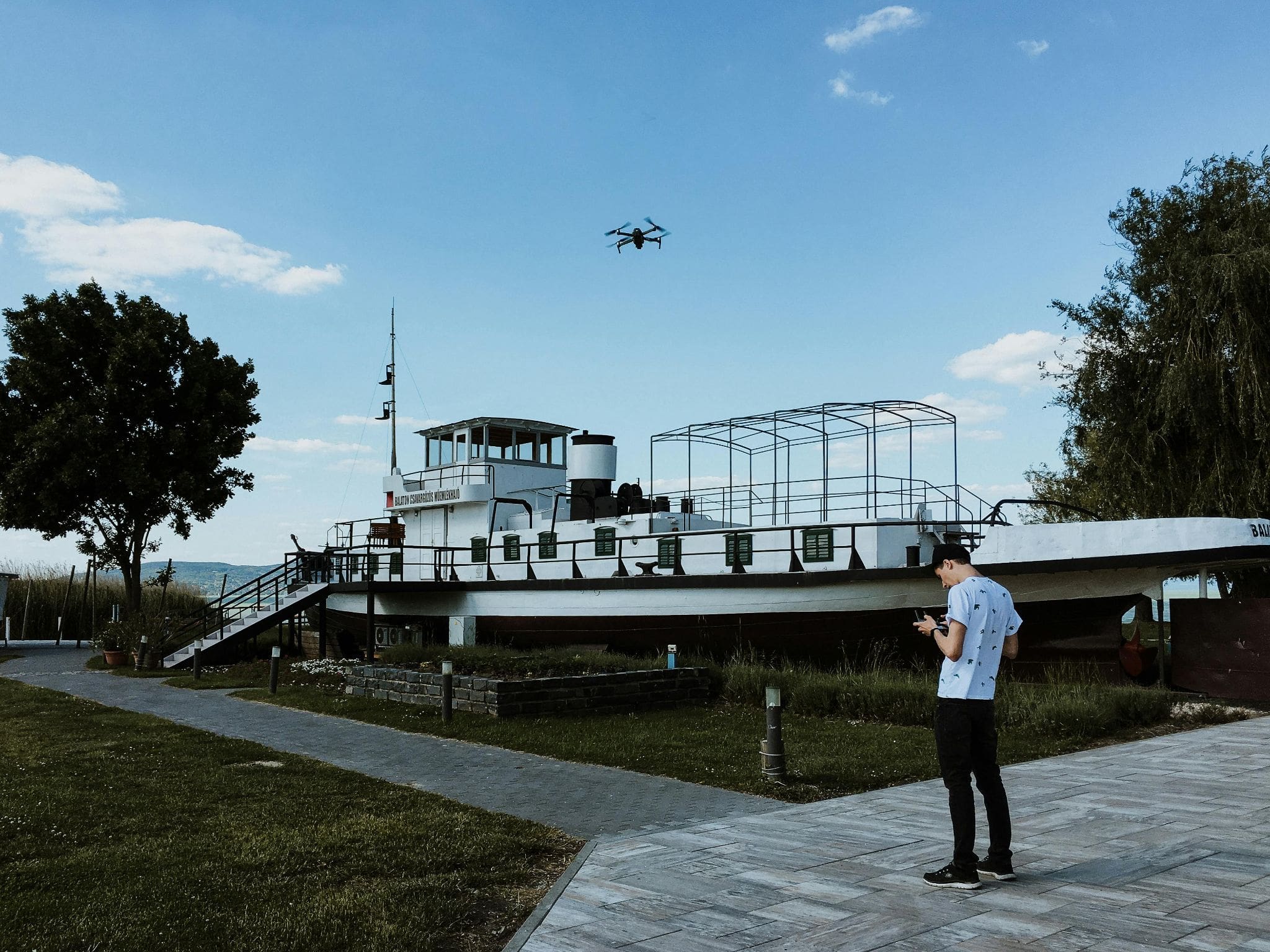 Man flying a drone in an outdoor setting